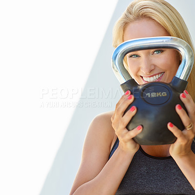 Buy stock photo Cropped portrait of a young woman holding a kettle bell