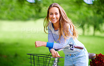 Buy stock photo Portrait of a young woman cycling in the park