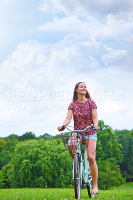 Buy stock photo Happy, bicycle and woman in summer for eco friendly or sustainable transportation in countryside. Blue sky, female gen z and travel or freedom in park or outdoor for journey, adventure and wellness 