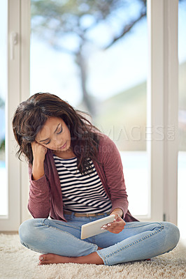 Buy stock photo Woman, tablet internet and relax on floor for reading ebook, streaming series and movie subscription in home. Female person, tech connection and watch online video, social media and scroll on carpet