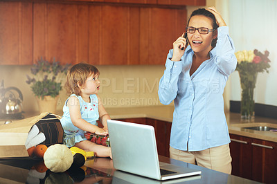 Buy stock photo Shot of a busy young mother at home with her baby