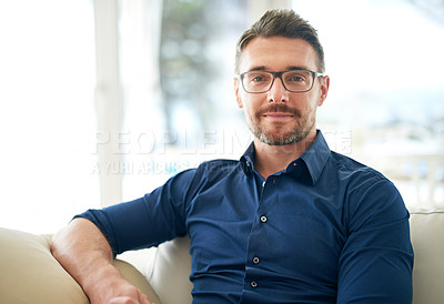 Buy stock photo Cropped portrait of a man sitting on the sofa at home