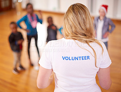 Buy stock photo Rearview shot of a volunteer working with little children