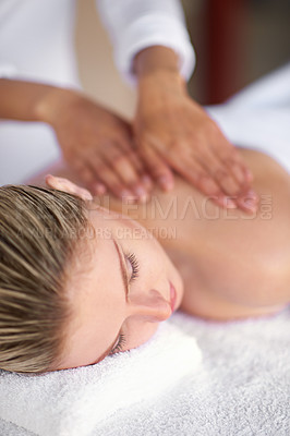 Buy stock photo Shot of a young woman enjoying a massage at the spa