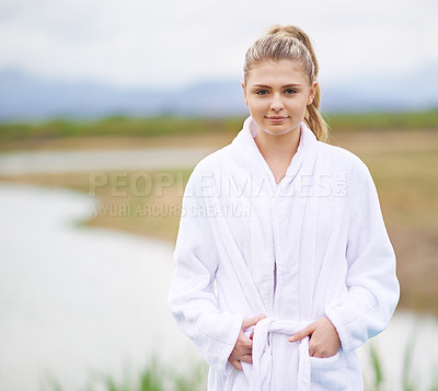Buy stock photo Shot of a young woman wearing a robe standing in the outdoors