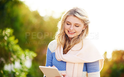 Buy stock photo Woman, tablet and smile in park for chat, communication and waiting for meet up from online dating profile. Gen z girl, tech and happy outdoor for notification, conversation and update in winter