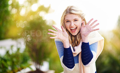 Buy stock photo Cropped portrait of a young woman gesturing excitedly outdoors