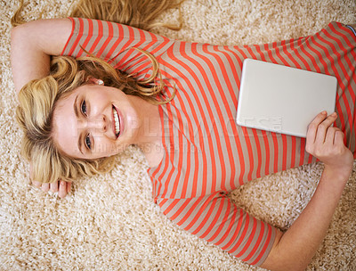 Buy stock photo High angle portrait of a young woman using her tablet at home