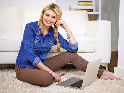 Buy stock photo Full length portrait of a young woman using her laptop at home