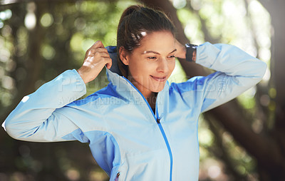 Buy stock photo Shot of a young woman warming up for a trail run