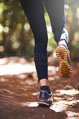 Buy stock photo Low angle view of a woman running on a trail