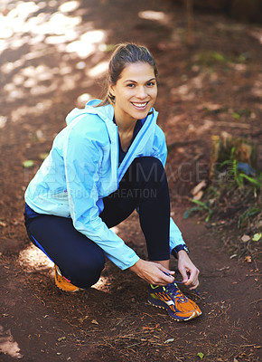 Buy stock photo Woman, runner and tie shoelace with smile for training, exercise or fitness to start morning in nature. Person, athlete and girl with shoes, sneakers or happy for workout with health in countryside