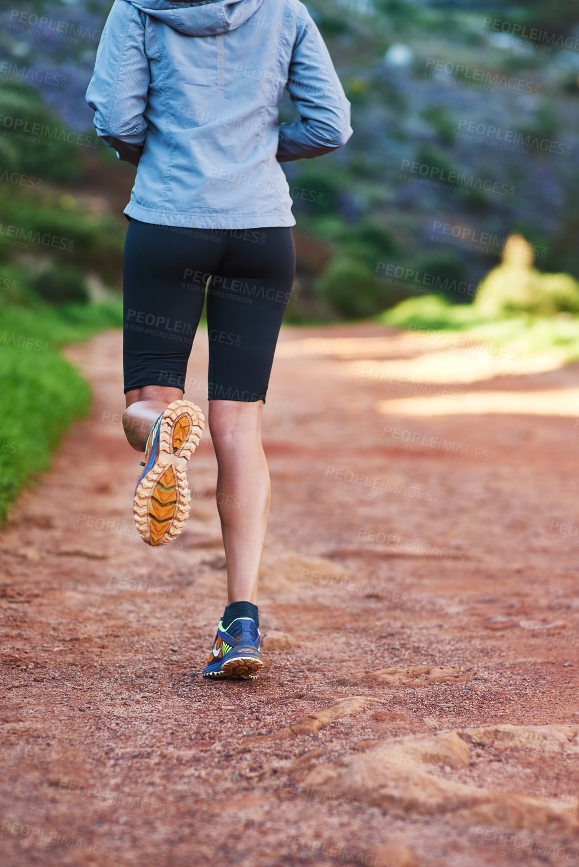 Buy stock photo Shot of a young woman out for a trail run