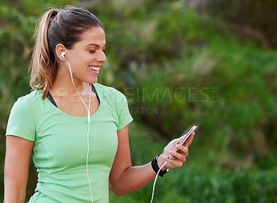 Buy stock photo Woman, earphones and smile with smartphone for fitness, exercise and wellness with music in park. Runner, headphones and phone for training, performance and cardio health with audio in nature