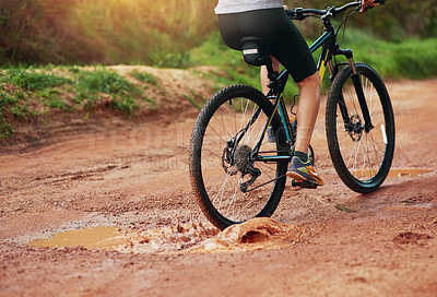 Buy stock photo Shot of a female mountain biker out for an early morning ride