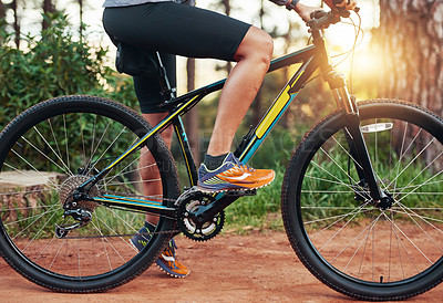 Buy stock photo Shot of a female mountain biker out for an early morning ride