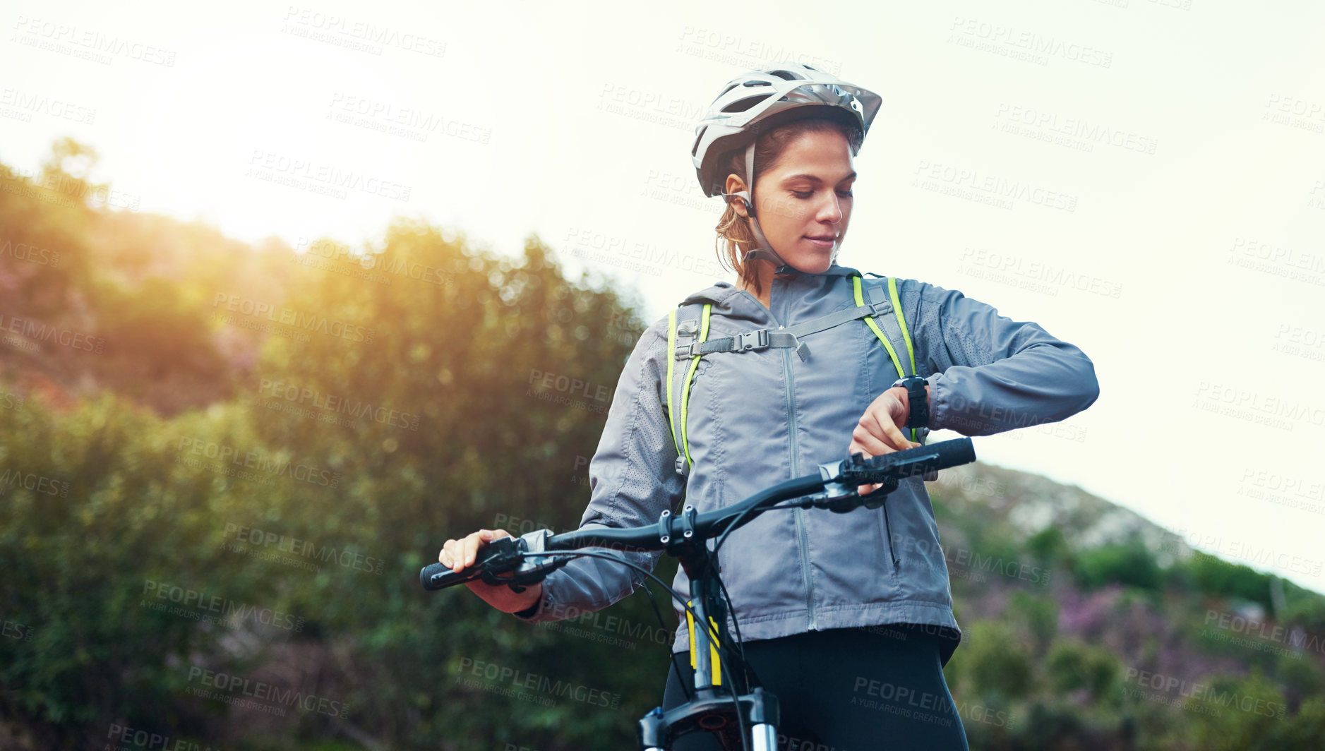 Buy stock photo Shot of a female mountain biker out for an early morning ride