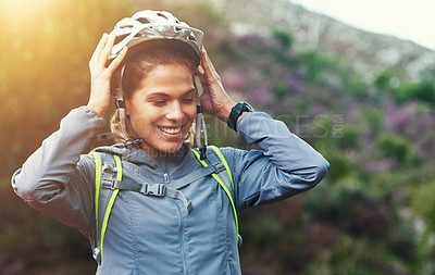 Buy stock photo Shot of a female mountain biker out for an early morning ride