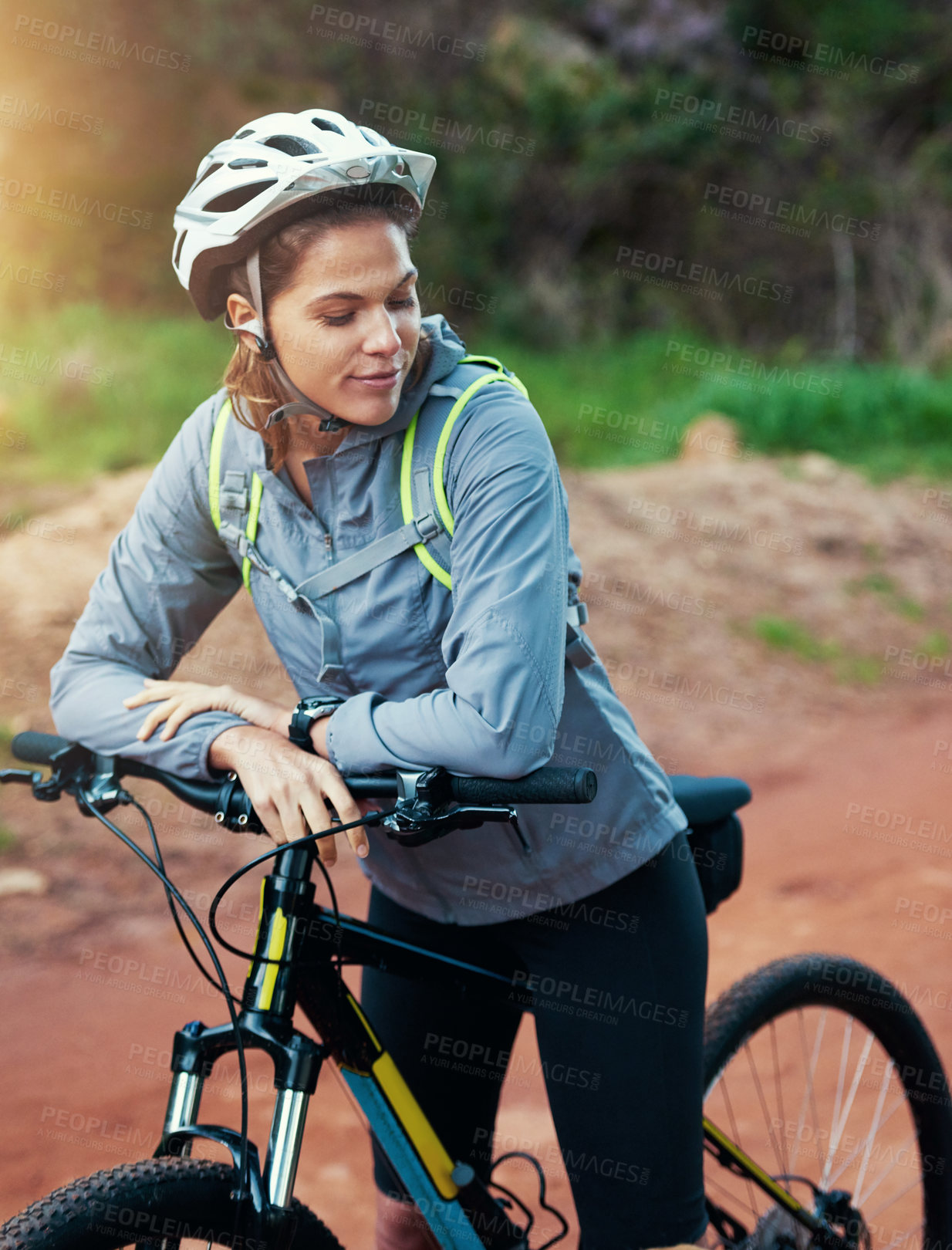 Buy stock photo Shot of a female mountain biker out for an early morning ride