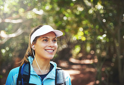 Buy stock photo Earphones, thinking and happy woman hiking in nature on outdoor adventure to explore on holiday vacation. Sightseeing, relax and hiker trekking in woods for training or travel for streaming music