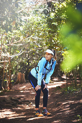 Buy stock photo Tired, runner and woman hiking in woods on trail or outdoor adventure to explore on holiday vacation. Girl, rest break or hiker trekking in nature for running training, fitness or travel with fatigue
