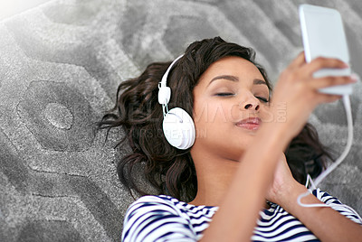 Buy stock photo Carpet, girl and smartphone or headphones for streaming music, podcast and cellphone for selfie. Social media, listening audio and female person with technology to relax, rest and wellness at home