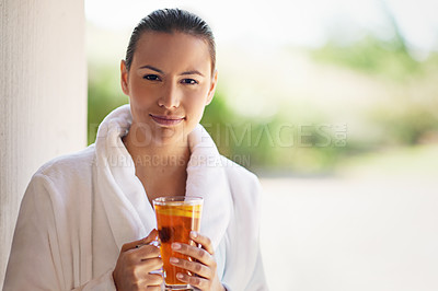 Buy stock photo Shot of a young woman drinking an iced tea at the day spa