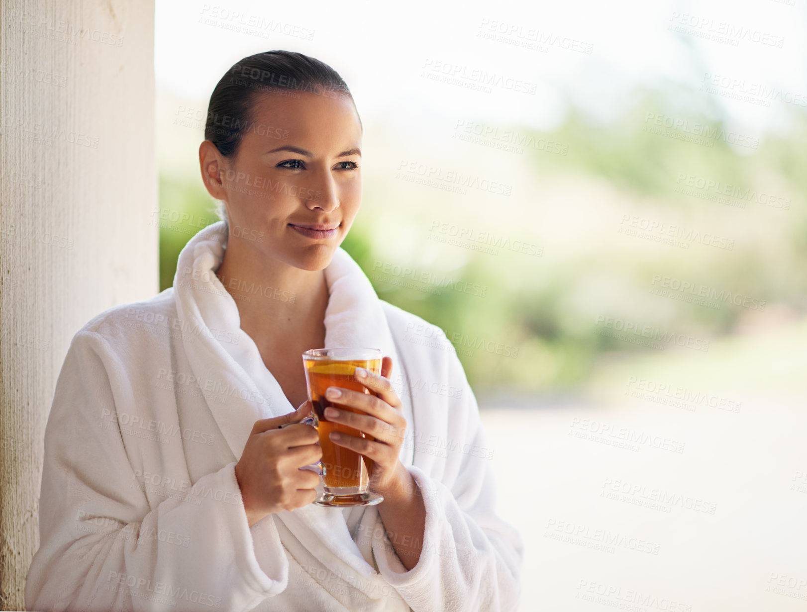 Buy stock photo Shot of a young woman drinking an iced tea at the day spa