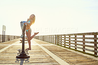 Buy stock photo Shot of a young woman standing by a binocular