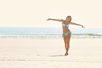 Buy stock photo Portrait of an attractive young woman walking on the beach