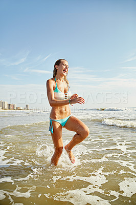 Buy stock photo Shot of an attractive young woman running on the beach