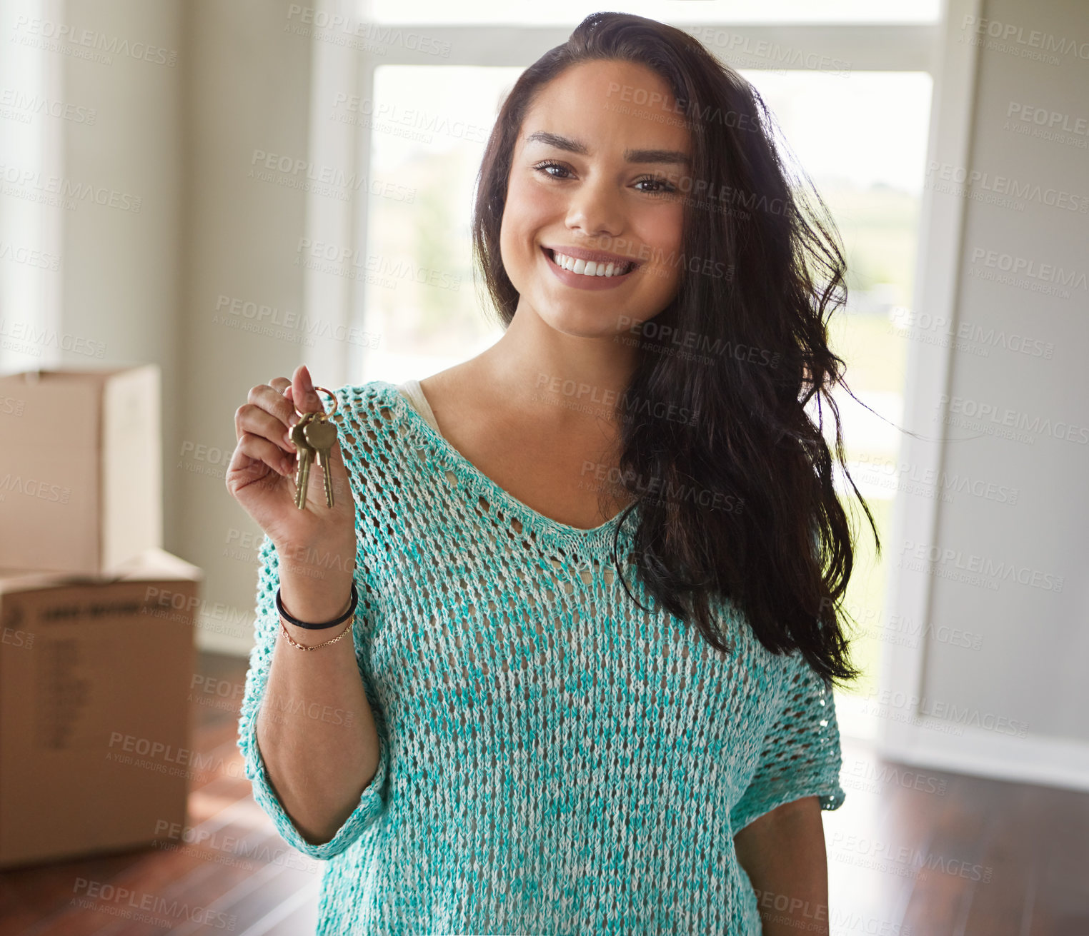 Buy stock photo Shot of a woman moving into her new home