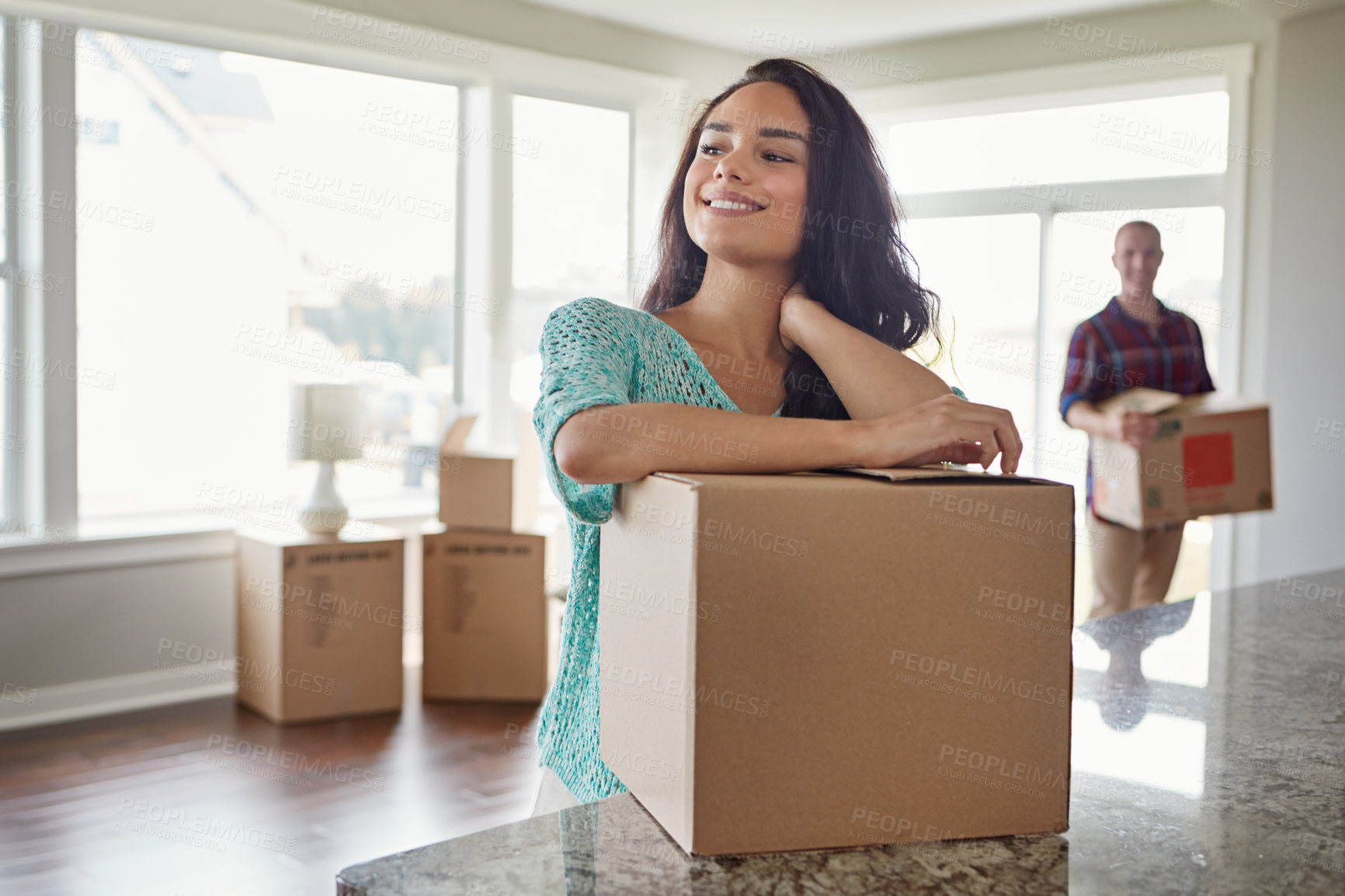 Buy stock photo Shot of a young couple moving into their new home