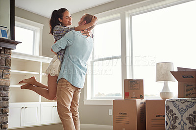 Buy stock photo Shot of a young couple moving into their new home