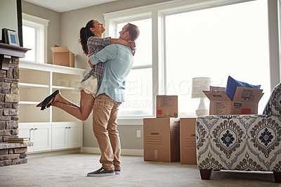 Cute couple hugging and smiling in their new home. Moving to new apparment.  Stock Photo