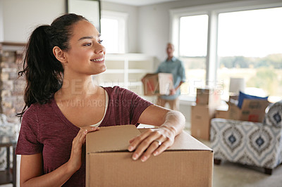 Buy stock photo Shot of a young couple moving into their new home