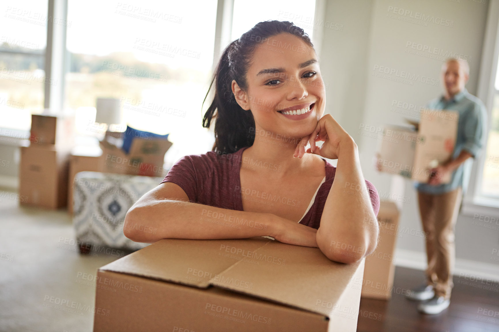 Buy stock photo Shot of a young couple moving into their new home