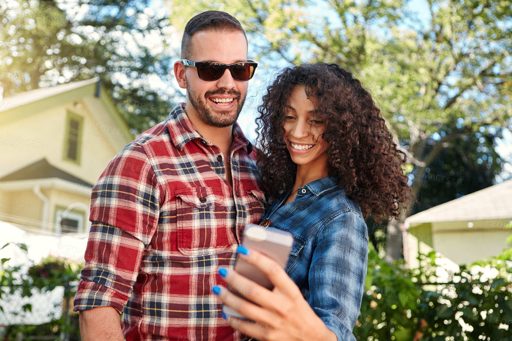Buy stock photo Couple, laugh and selfie at backyard, romance and memory for social media post, outdoor and together. Happy, man and woman with smile for picture, photography and interracial marriage, online or home