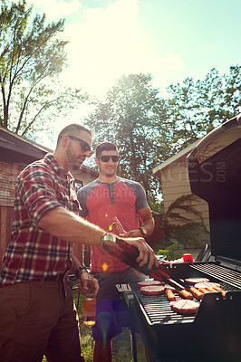 Buy stock photo Shot of friends having a barbecue outside