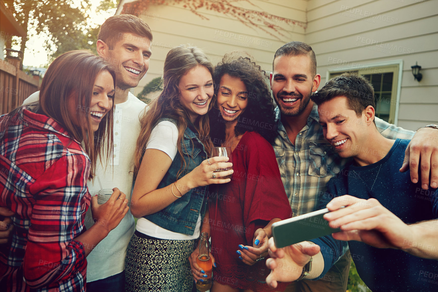 Buy stock photo Shot of a group of friends taking a selfie outside