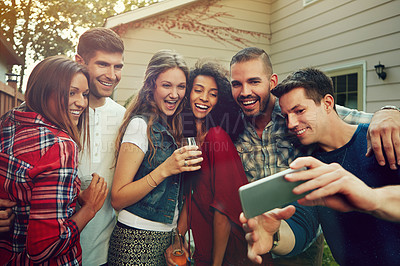 Buy stock photo Shot of a group of friends taking a selfie outside