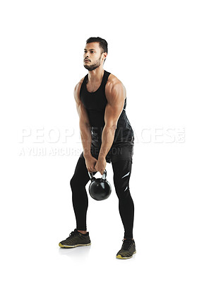 Buy stock photo Studio shot of a fit young man working out with a kettle bell against a white background
