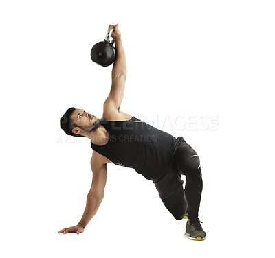 Buy stock photo Studio shot of a fit young man working out with a kettle bell against a white background