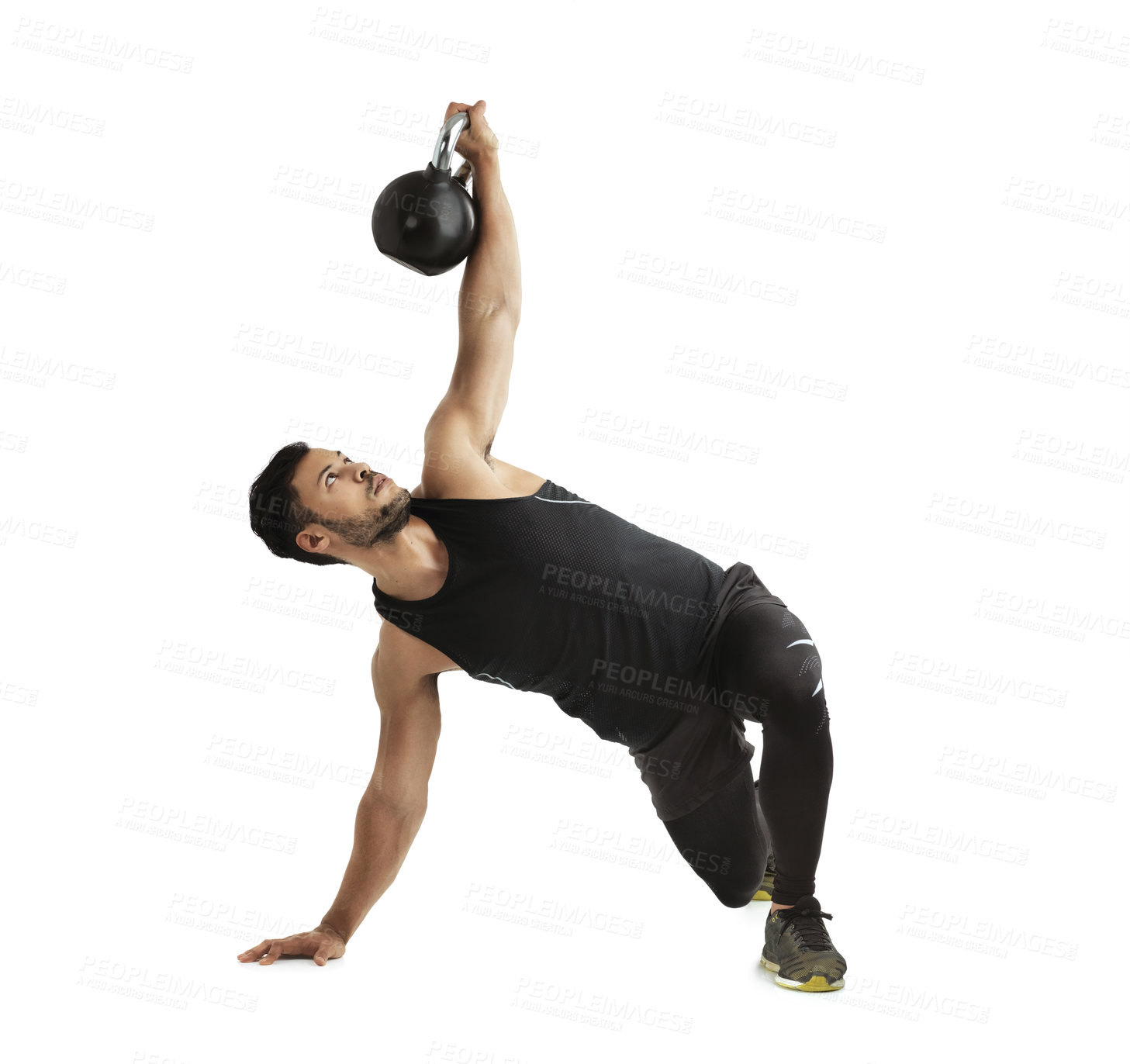 Buy stock photo Studio shot of a fit young man working out with a kettle bell against a white background