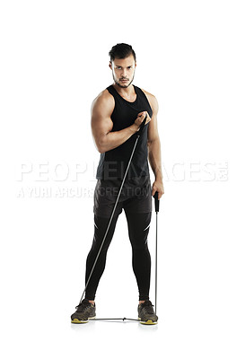 Buy stock photo Studio shot of a young man working out with a resistance band against a white background
