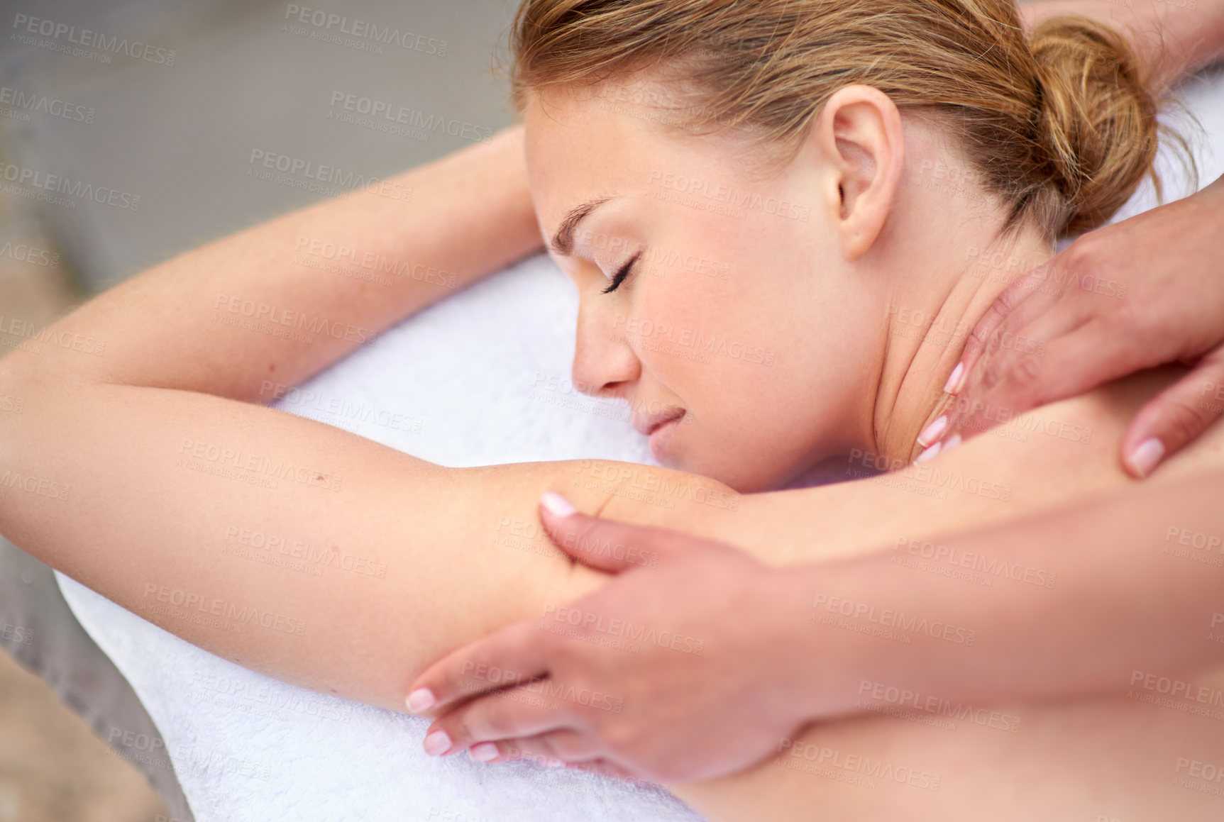 Buy stock photo Cropped shot of a young woman enjyoing a massage at the day spa