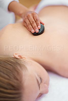 Buy stock photo Woman, relax and table in spa with stone, therapy and self care for body wellness and resting for tension. Comfortable and resort with client, treatment and healing, calm session and cosmetology