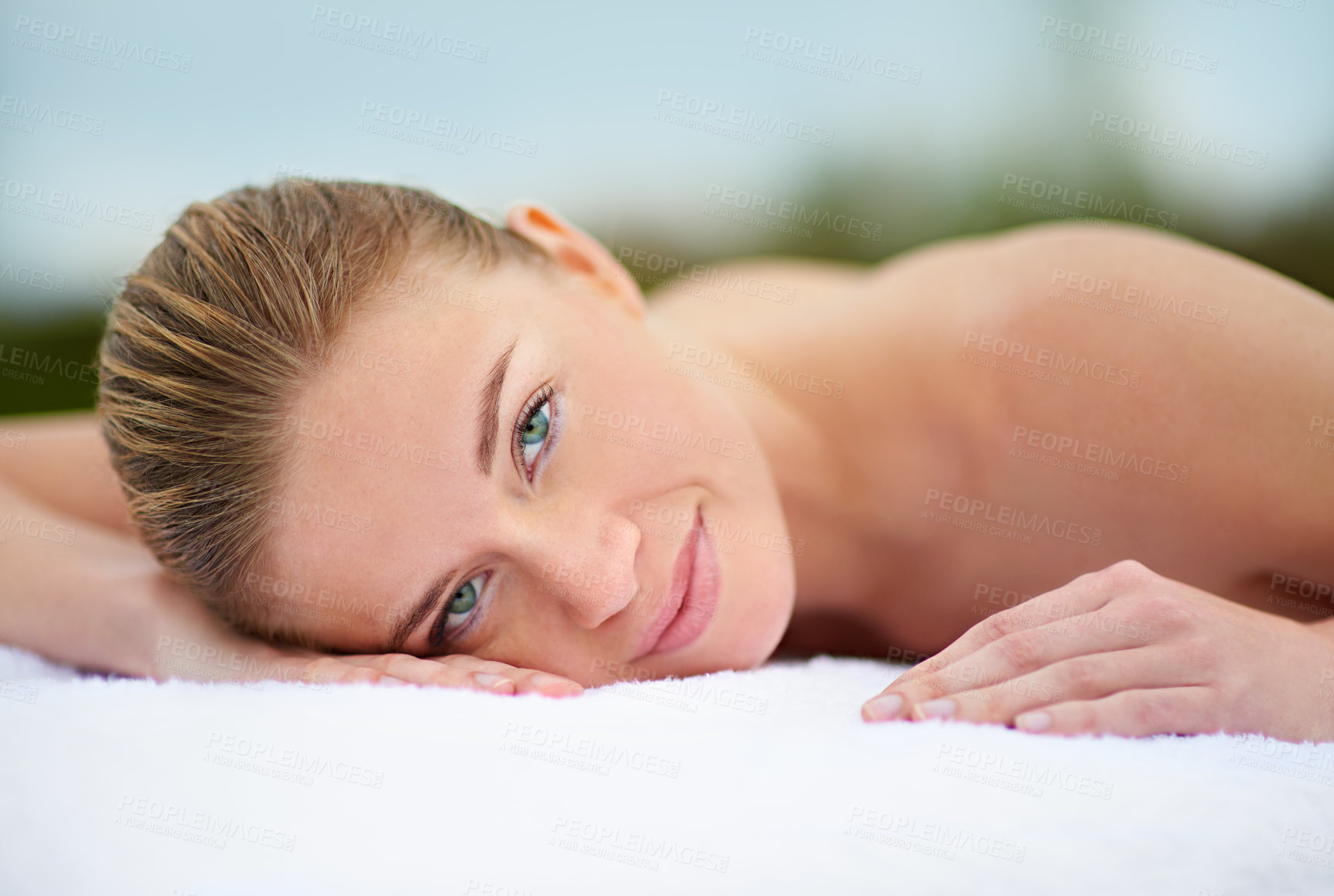 Buy stock photo Cropped portrait of a young woman lying on a massage table