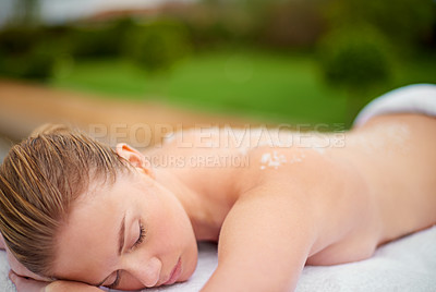 Buy stock photo Woman, relax and table in spa with salt, therapy and self care for body wellness and resting for tension. Comfortable and resort with client, treatment and healing, exfoliate session and cosmetology