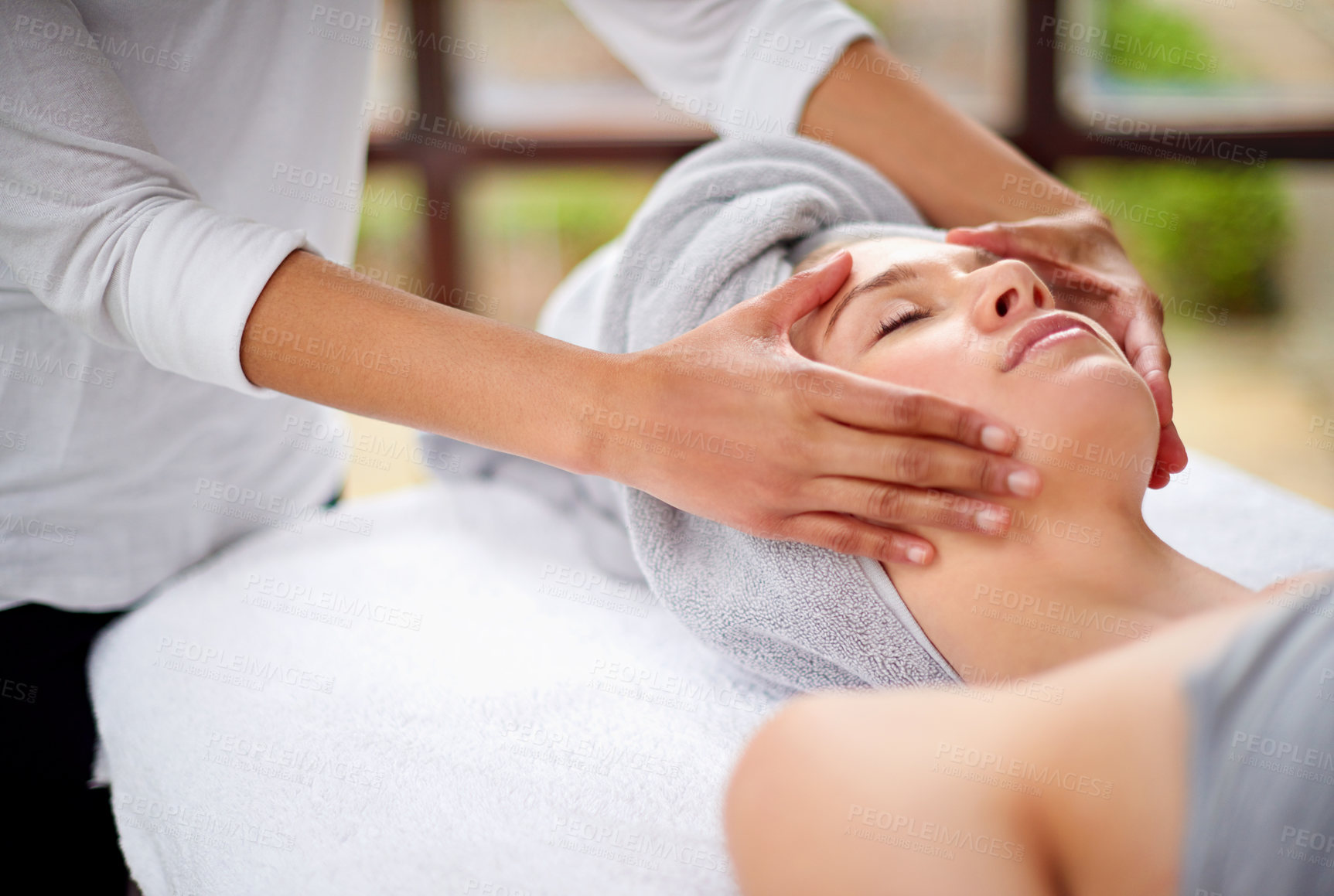 Buy stock photo Cropped shot of a young woman enjyoing a massage at the day spa